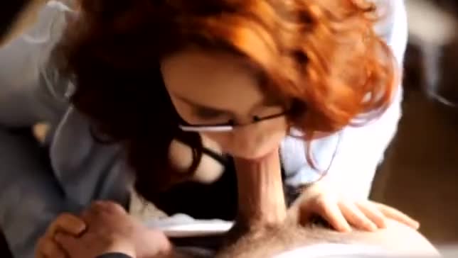 Redhead with glasses giving head
